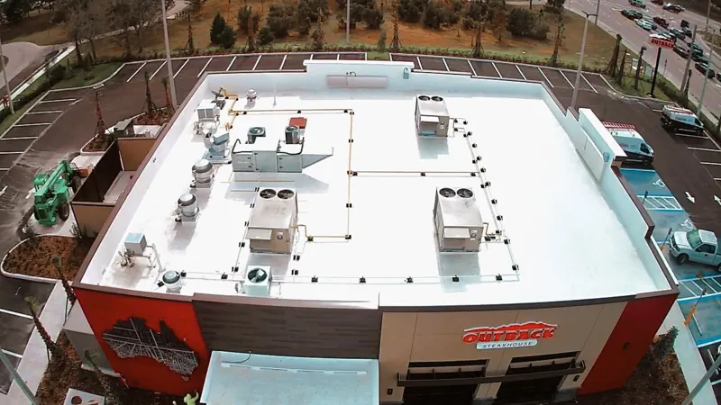 Aerial view of a white coated flat roof on a restaurant, Big River Roofing