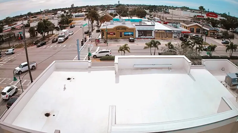 Aerial view of a white flat roof on a commercial building, Big River Roofing
