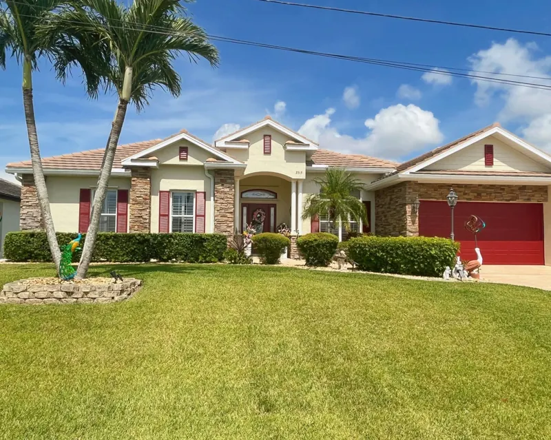 Tile roof on a single-story stucco home with stone accents, Big River Roofing