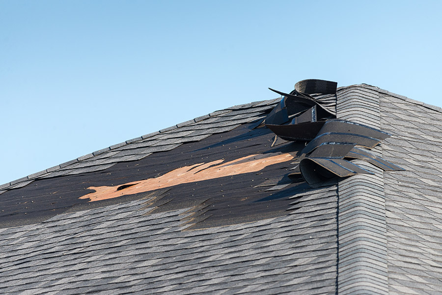 residential property roof close up with shingles damages cape coral fl