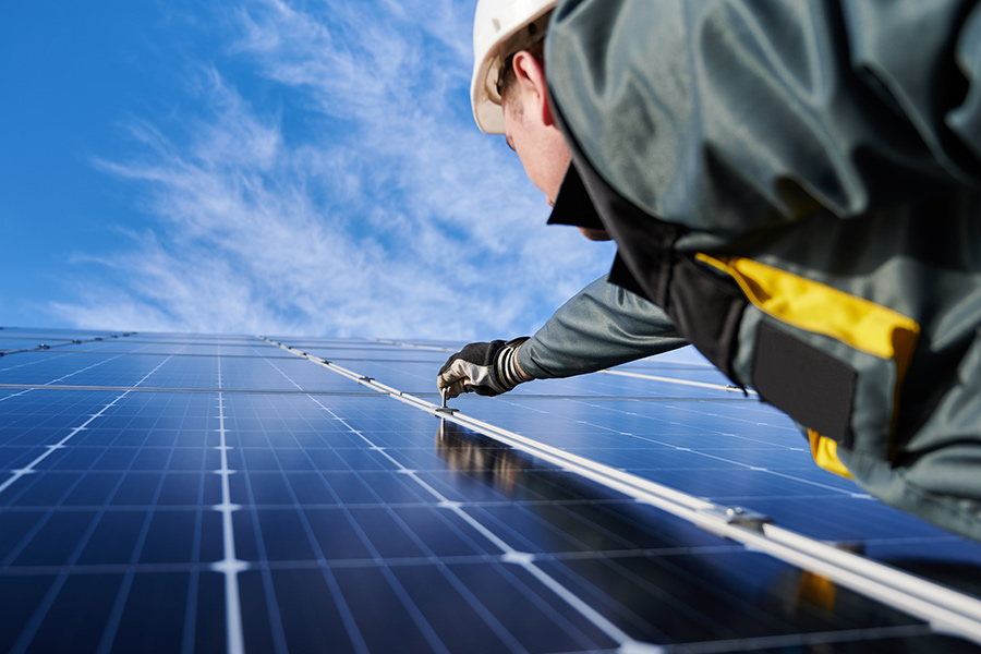 contractor close up installing solar panels at property estero fl